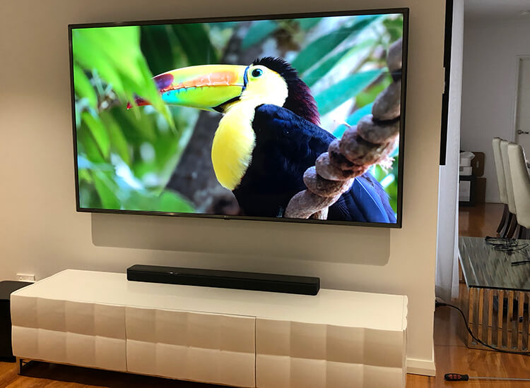 TV mounted on external wall with cables hidden in wall