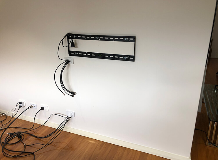 TV wall-mount bracket on external wall with cables hidden in wall