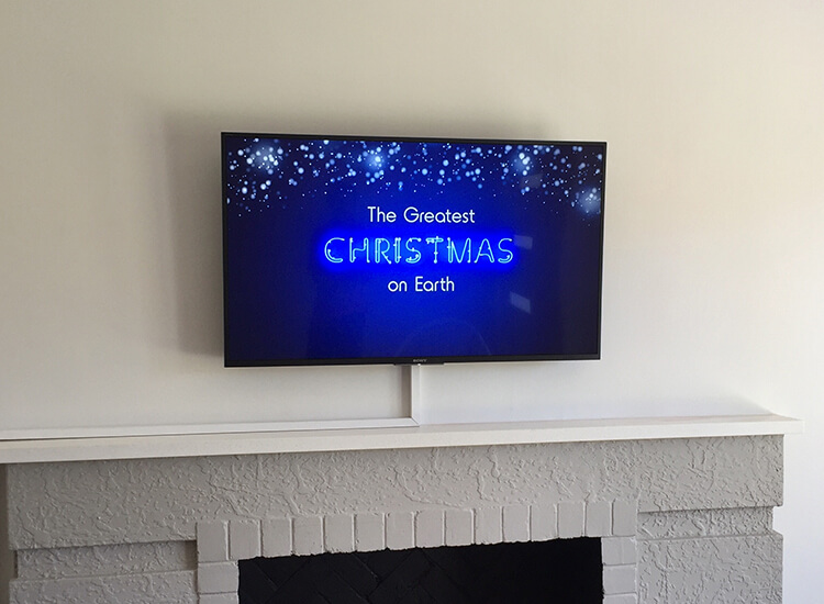 TV wall mounted above fireplace