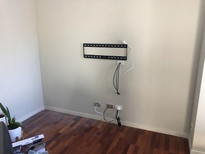 Cables on this TV installation will be hidden on the opposite side of the wall.