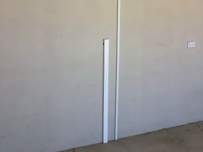 Shows TV cables that are positioned on this wall so as not to be seen on the other side where the TV is mounted.