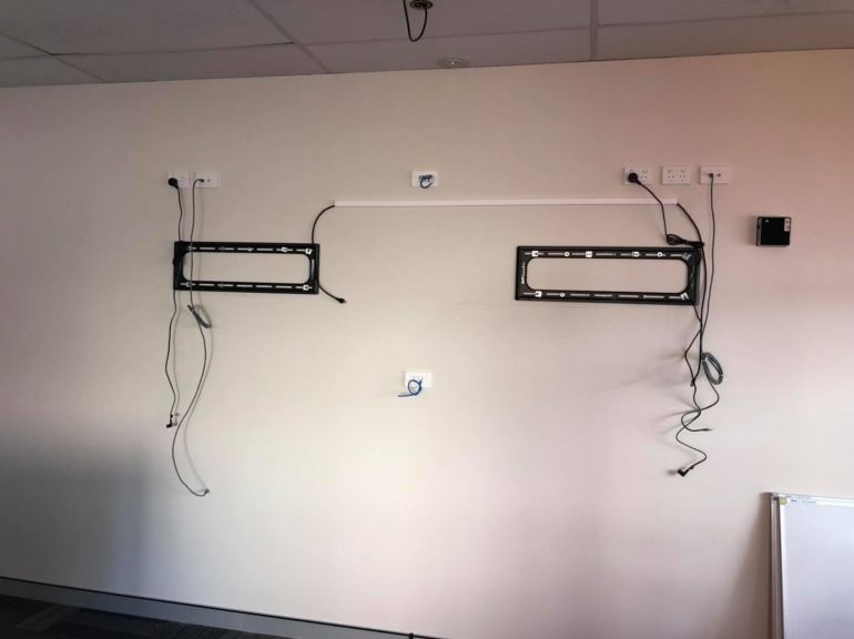 setting up the cabling for mounting two tvs in kings park office