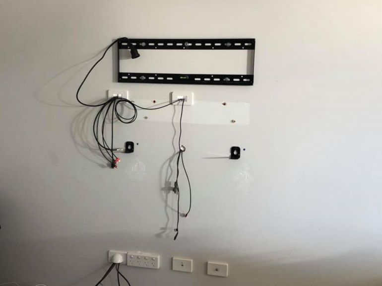 TV bracket and cables before mounting panasonic tv and soundbar