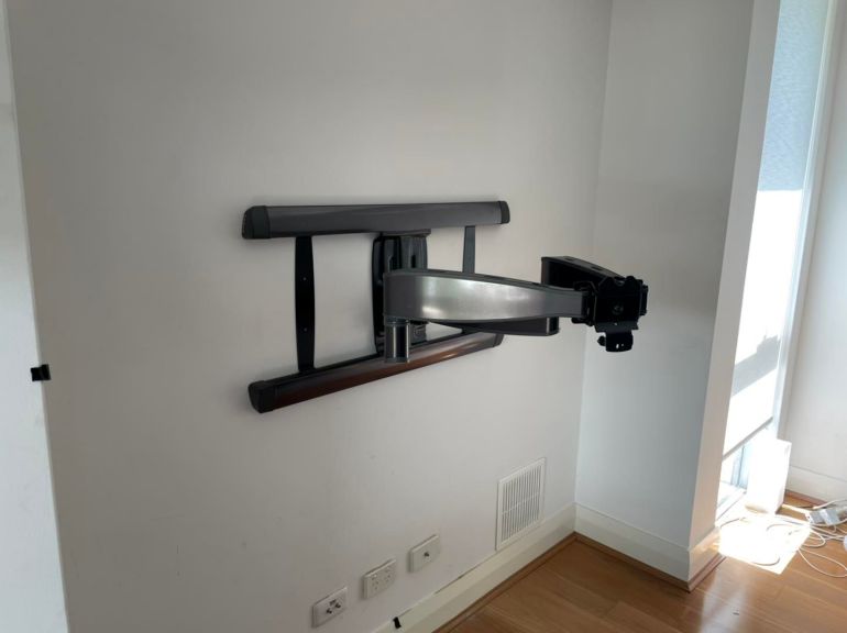 sanus advanced full motion bracket installed on the wall.