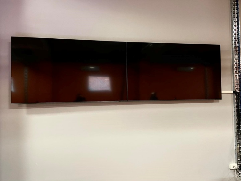 two tv's wall mounted side by side in an east perth office