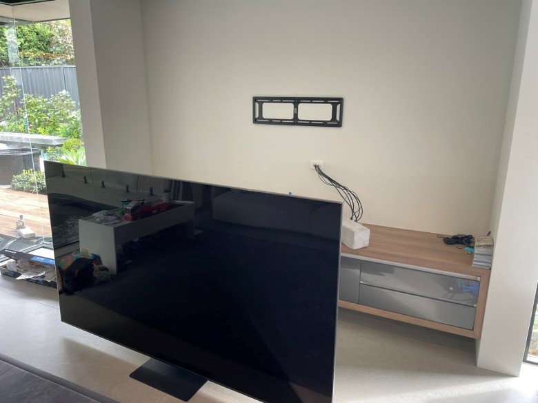 the tv bracket is fitted before mounting the huge 98" tv