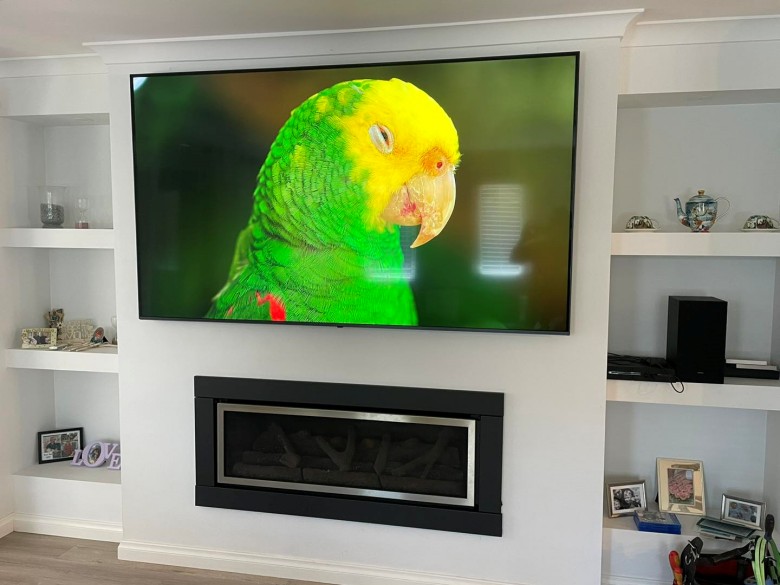 86" lg tv mounted in a wall recess in quinns rocks home