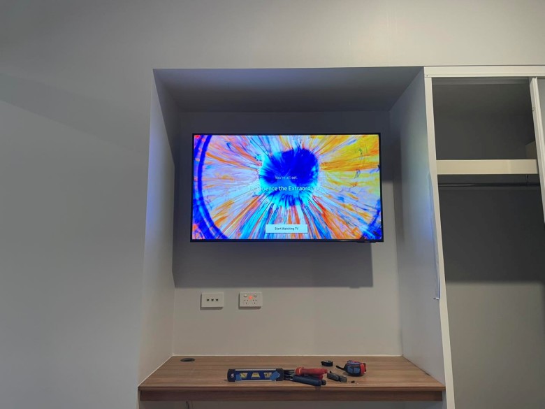 smaller tv installed in deeper recess above shelf