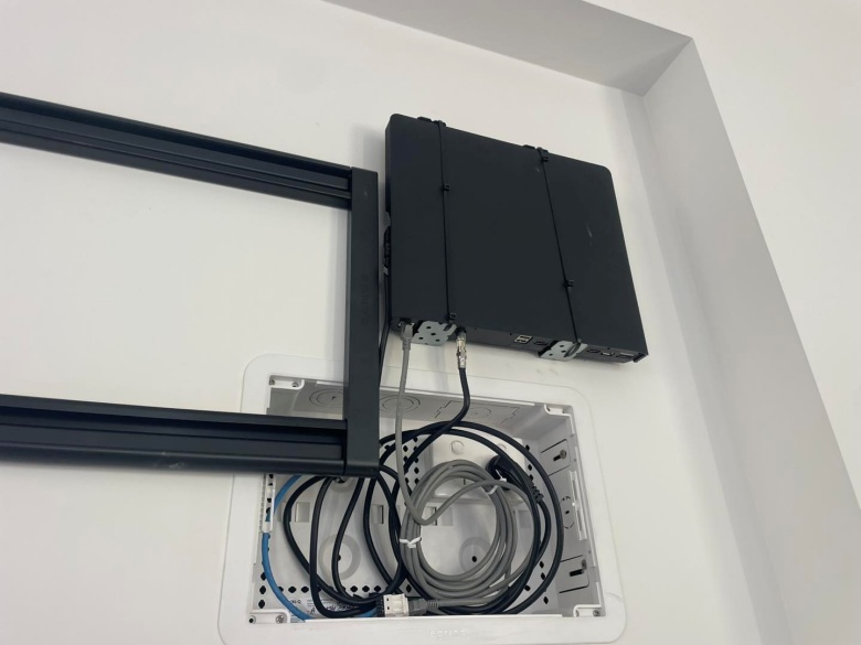 close up of tv bracket and one connect box on the wall