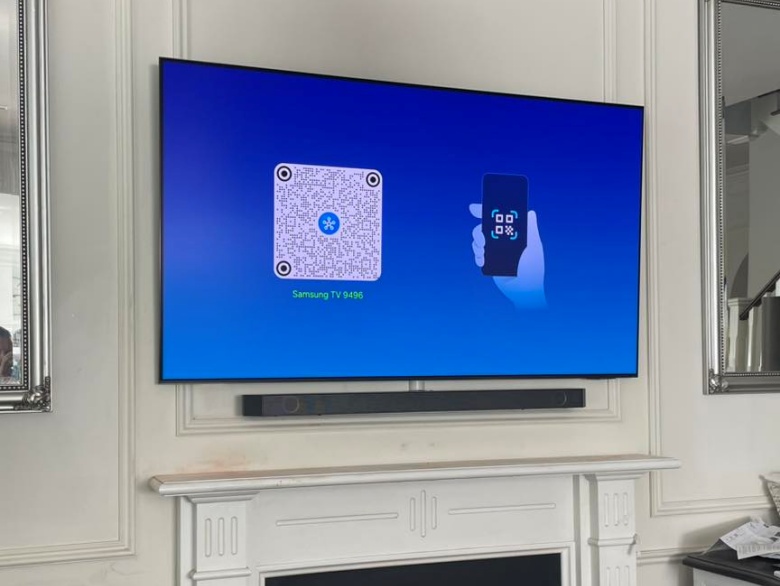 tv hung on wall above the fireplace